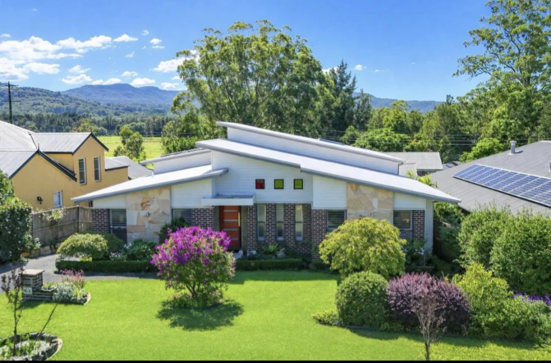 The Gables Berry exterior with landscaped front garden and hills beyond